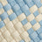 Close-up of a woven pattern featuring alternating blue and cream-colored ribbons, highlighting intricate texture.