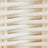 Close-up of light-colored wicker weaving pattern, showcasing the intricate texture of overlapping horizontal and vertical strips.