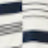 Close-up of a white fabric with horizontal black and gray stripes, some lines appearing blurred for an abstract textile pattern.