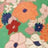 A variety of colorful flowers, including orange, red, white, and pink blooms, are arranged against a green background.