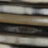 A close-up view of a stack of blurred magazines, with spines and pages barely distinguishable.