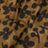 Close-up of brown fabric featuring a black floral or abstract print design.