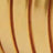Close-up of a golden surface featuring curved, vertical grooves that catch the light.