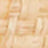 A close-up, blurred image showing a light tan, woven or textured surface.