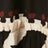 Close-up of black fabric featuring a row of red dots and a ruffled beige trim accent.