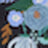 A blurred image featuring blue flowers and green leaves with a white oval shape in the scene.