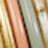 Blurry image featuring vertical bands of color, such as yellow, peach, green, and beige, creating an abstract pattern with indistinct details.