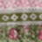 A blurred image featuring horizontal bands of pink, green, and white patterns with floral and geometric designs creates an abstract composition.