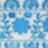 Blurry image showing a blue floral and geometric pattern on a light background.
