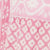 Close-up of pink and white fabric featuring two distinct floral patterns divided by a neat seam.