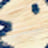 A blurred, close-up image with tan and dark blue colors, possibly depicting an abstract or out-of-focus object or surface.