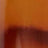 A close-up image displays a gradient of brown and orange tones with a blurry, abstract texture.