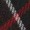 Close-up of two intertwined ropes, one black with white accents and the other red, set against a dark surface.