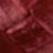 A blurred close-up image reveals various shades of red and maroon, with abstract shapes and textures blending together.