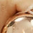 A close-up view highlights a gold ring elegantly worn on a finger, showcasing its radiant shine.