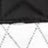 Close-up of fabric with a black section on top and a white section below, featuring a diamond-shaped quilted pattern.