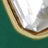 Close-up of a faceted, clear gemstone set in a gold bezel, featuring dazzling clarity and precision-cut facets.
