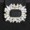 A rectangular silver or metallic brooch with an ornate, symmetrical design featuring pointed edges and a lustrous finish.