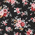 A pattern of pink and red roses with white leaves scattered across a black canvas.