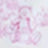 A blurred image with indistinct pink and white shapes, possibly depicting a figure or an object, set against a light background.