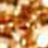 The image is heavily blurred, featuring indistinct shapes with warm brown, yellow, and white hues, creating an abstract and unidentifiable scene.