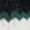 A close-up of a striking zigzag pattern in dark green and black on top, blending into crisp white below.