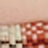 A blurred image displays a grid pattern of red, white, and beige colors with a soft overlay on top.