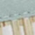A blurry close-up image displays a textured, light gray surface with a subtle beige and tan striped pattern below, highlighting the unique material.