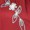 A silver butterfly-shaped brooch with rhinestones and a white flower detail is pinned on rich red fabric.