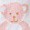 A soft pink teddy bear with a light brown nose and black eyes is shown cuddling gently, radiating warmth.