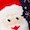 Close-up of Santa Claus’s face, featuring a white beard, red hat, and small white spots resembling snow.