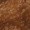 Close-up image of a textured brown surface, possibly resembling fur or carpet fibers, showcasing its soft and fuzzy material.