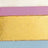 Close-up of three horizontal bands in white, pink, gold, and blue tones, possibly part of a vibrant multi-colored design.