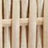 Close-up view of a light-colored woven rattan texture with vertical and horizontal strips, showcasing the intricate craftsmanship.