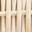 Close-up view of a light-colored wicker or rattan weave pattern, highlighting the detailed interlaced vertical and horizontal strips.