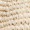 Close-up of a woven natural fiber texture, possibly straw or jute, featuring a striking diagonal pattern and intricate detailing.