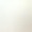 A plain, light beige surface with a slightly uneven texture and soft lighting, creating a subtle, neutral tone.