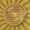 A gold coin featuring a sunburst pattern radiating outward and an intricate celestial design at its center.