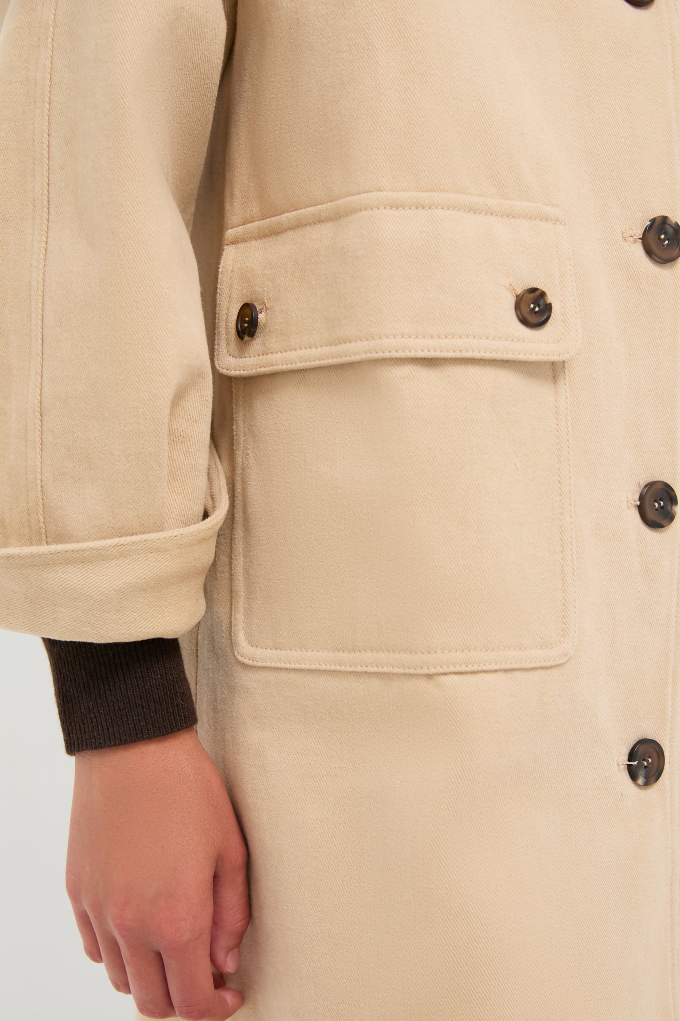 Close-up of the Beige and Navy Oakley Coat featuring a classic design with large flap pockets and ribbed cuffs, showcasing effortless, high-end style.