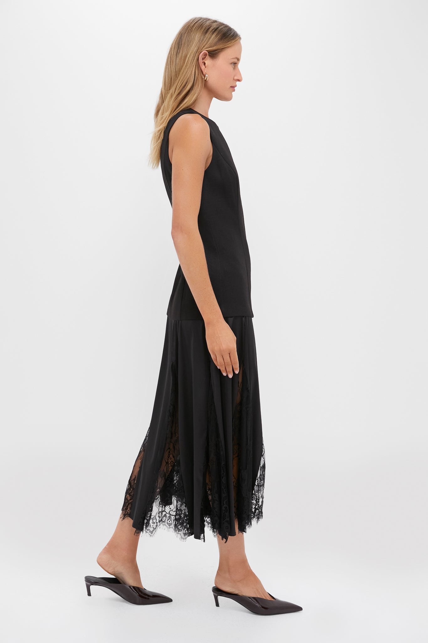 Model in Black Mixed-Media Coco Maxi Dress, featuring an effortless tunic-style bodice and classic lace-paneled skirt, embodying Tuckernuck's fun and high-end fashion ethos.