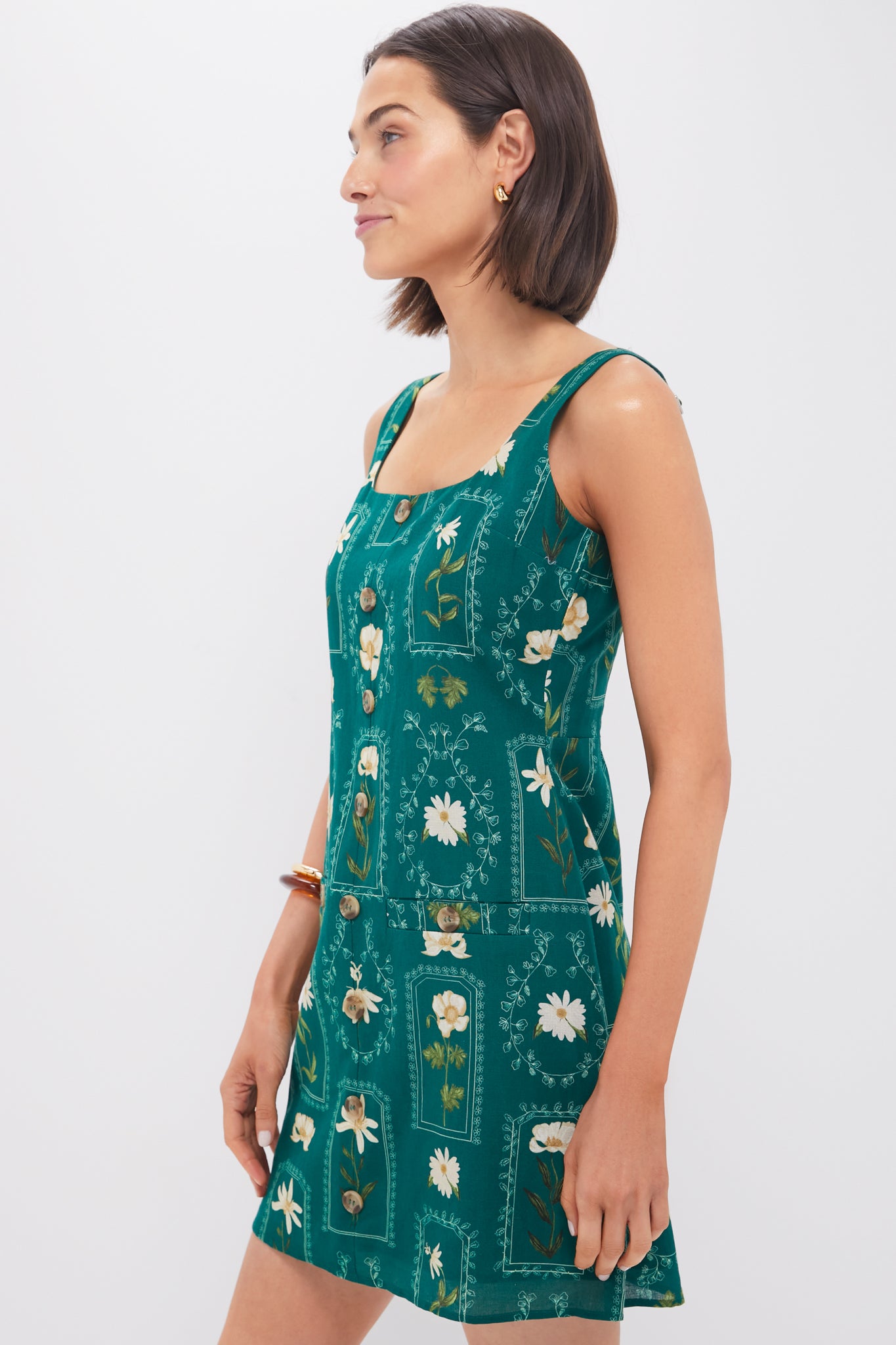 Woman in classic Teal Stem Merrit Mini Dress with floral motifs and square neckline, evoking effortless, high-end style.