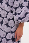 Lilac & Navy Floral Jacquard Janie Mini Dress features a classic, high-end look with large lilac poppy flowers on navy, puffed sleeve detail, and an effortless, fun style.