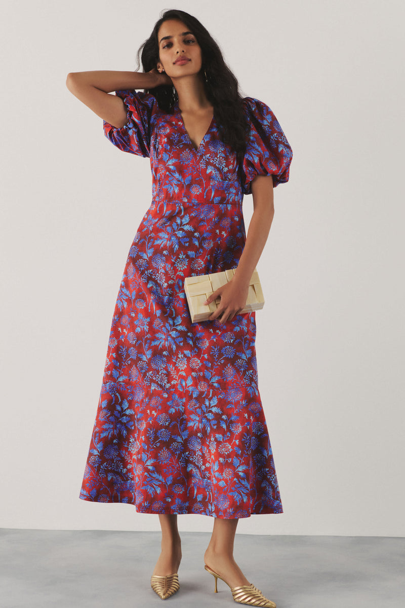 Woman in a red and blue floral patterned dress. 