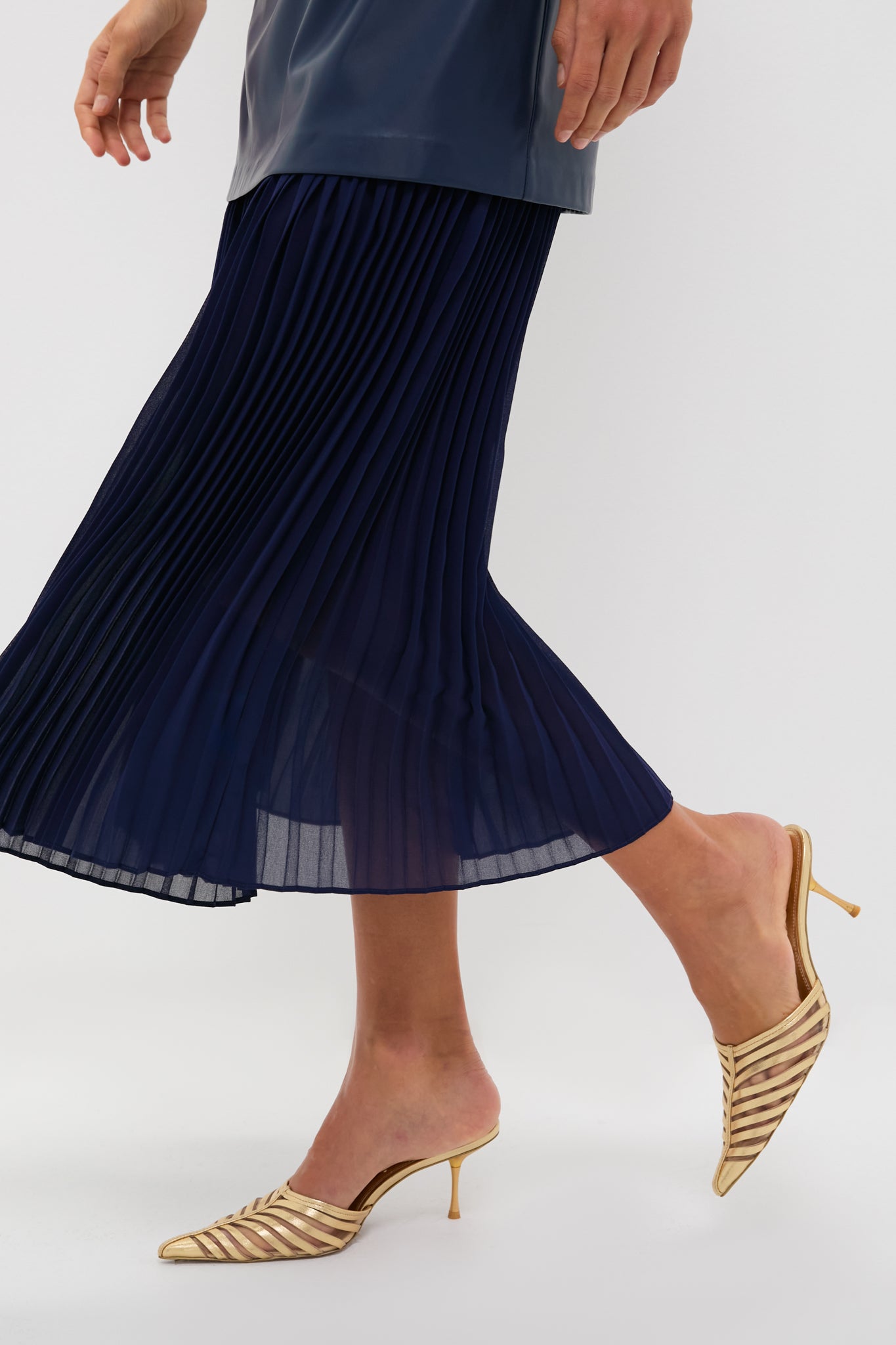 Mixed Media Leather Pleated Ozzy Midi Dress: classic, high-end look with an effortless navy pleated skirt and gold strappy heels, perfect for fun, elevated occasions.