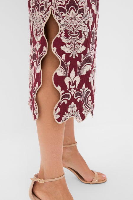 Blush Pink and Burgundy Bicolor Jacquard Waves Midi Skirt with ornate damask embroidery and scalloped-edge side slit, styled with nude ankle-strap sandals for an effortless, classic look.