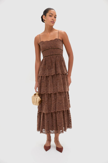 Model in Sepia Lace Leina Midi Dress with classic tiered velvet lace, holding a tan handbag; effortless, high-end look with fun, adjustable straps and fitted bodice.