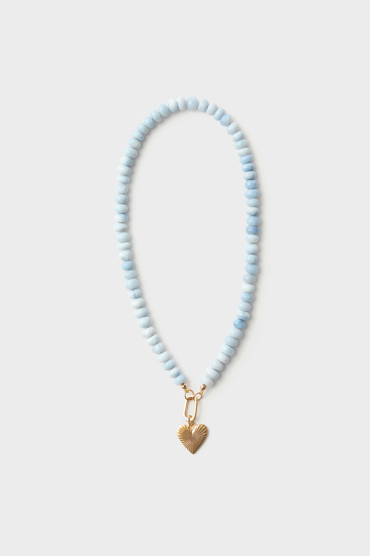 A HART for Tuckernuck exclusive beaded necklace with light blue opal beads and a gold heart charm.