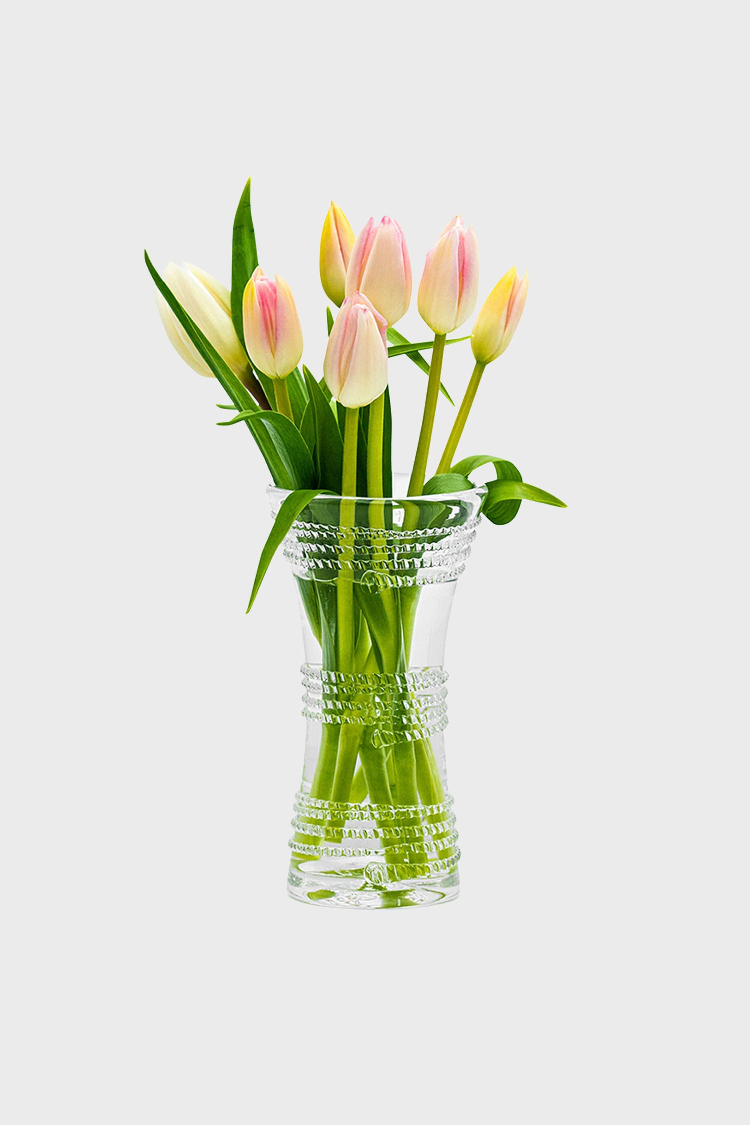 Ella 6 Corset Vase features a classic, hourglass design with decorative raised bands, effortlessly showcasing blush-white tulips for a fun, high-end look in small spaces.