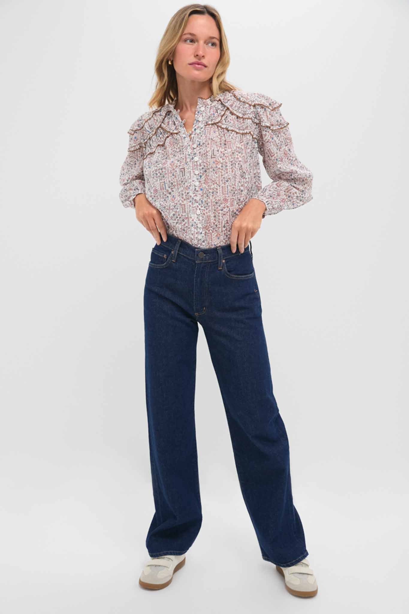 Woman models Reissue Mid Rise Relaxed Straight Harper Jean, showcasing a classic, effortless look with its high-end, dark-indigo finish and fun, wide-leg silhouette.