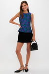Navy & Indigo Jacquard Floral Ivy Blouse styled effortlessly with a black mini skirt and slingback shoes, embodying classic femininity with a fun, high-end appeal.